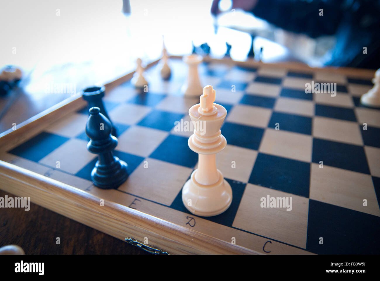 A king chess piece with others in background. Low depth of field, focus on foreground Stock Photo