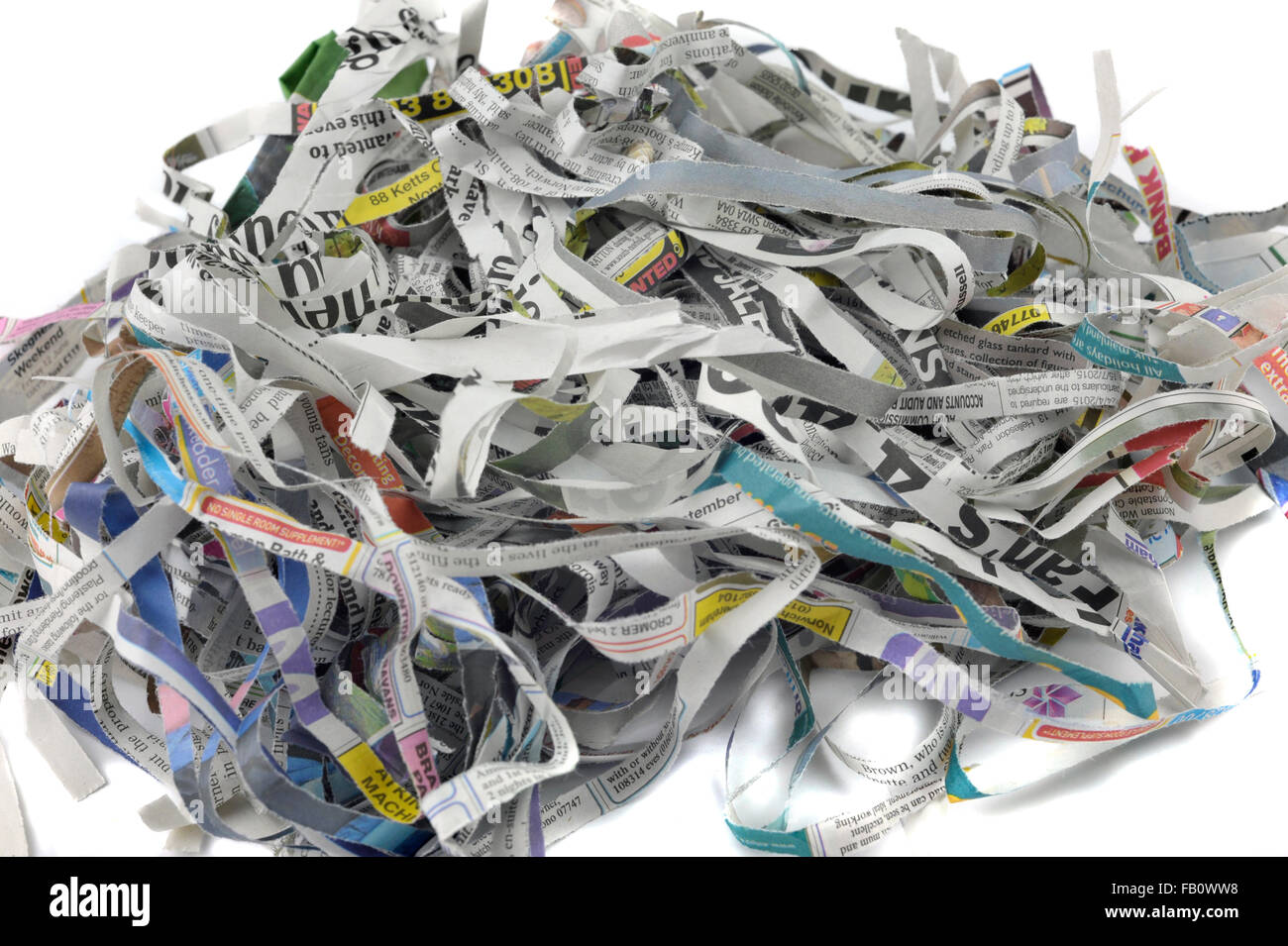 Shredded newspaper for re-use as packing material, animal bedding, garden mulch and composting. Stock Photo