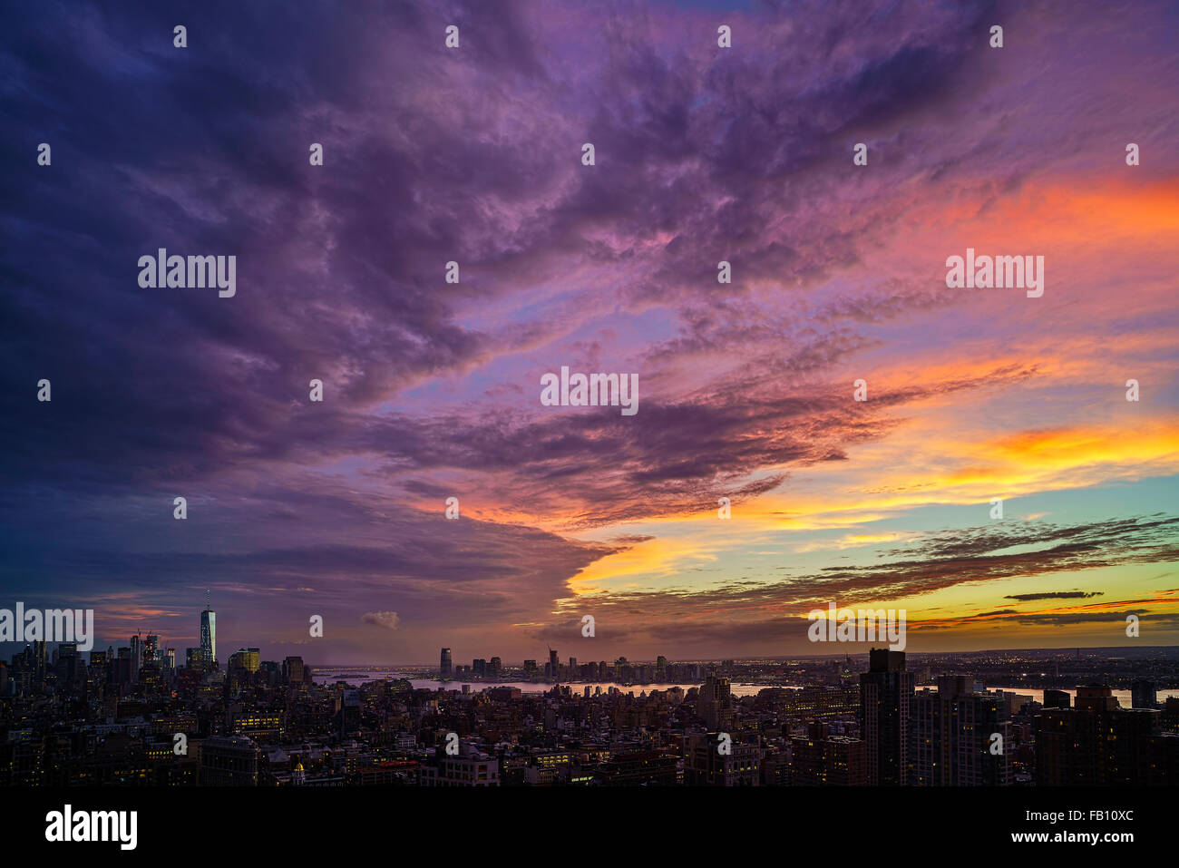 Dramatic sky over city at sunset Stock Photo