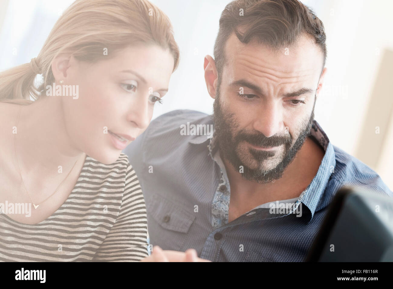 Man and woman looking at computer Stock Photo