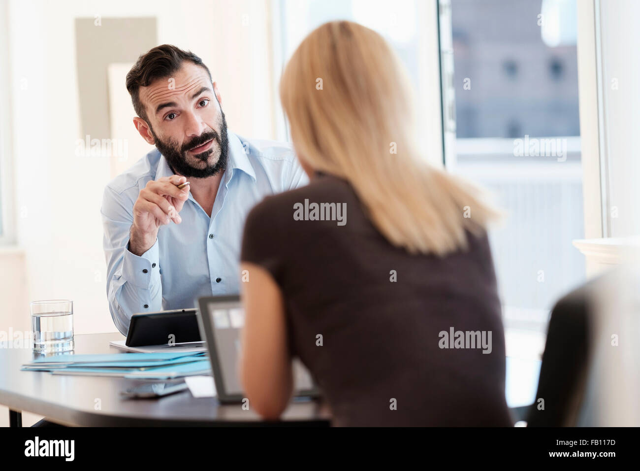 Man and woman talking in office Stock Photo