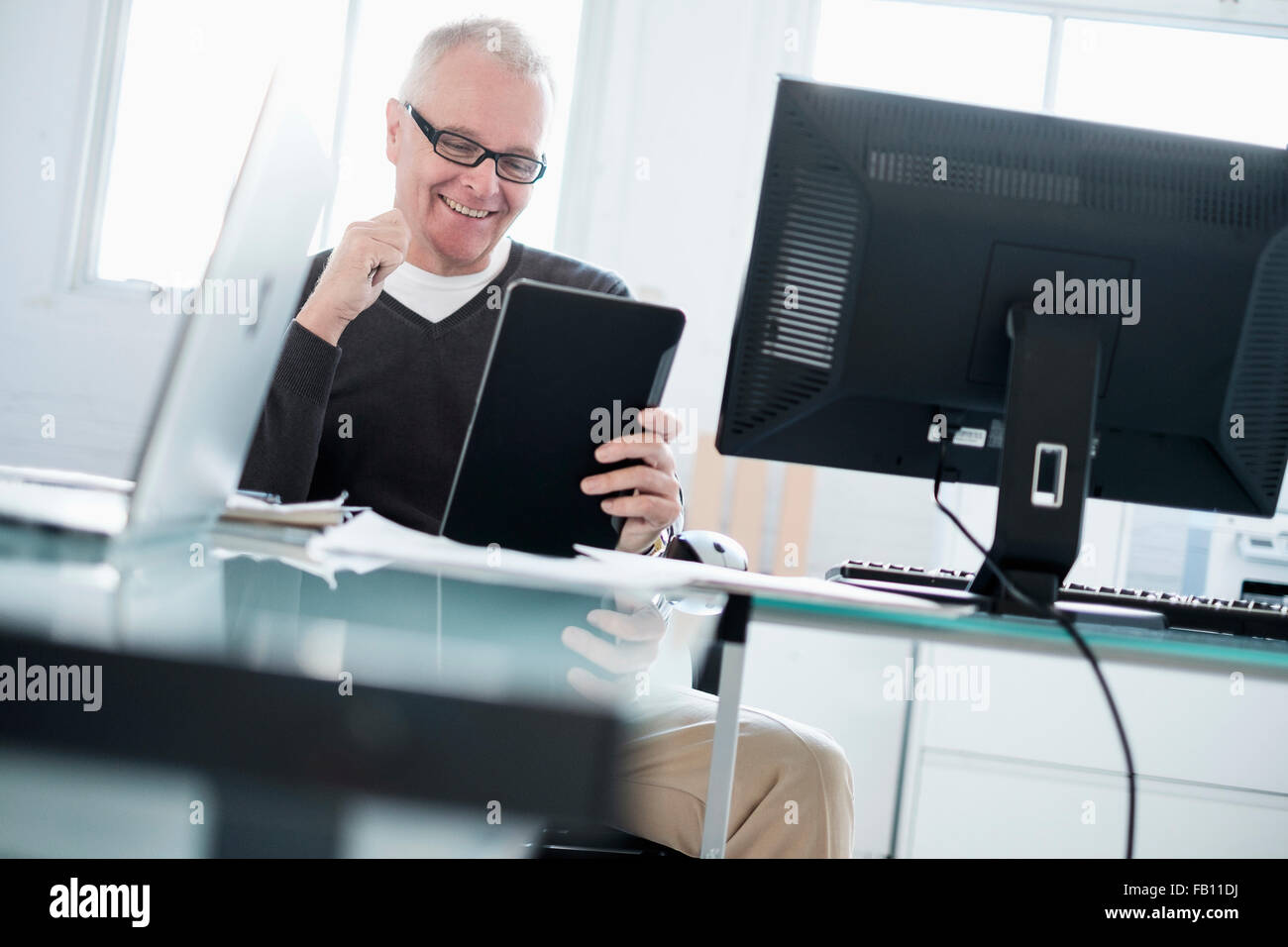 Man in office using tablet Stock Photo