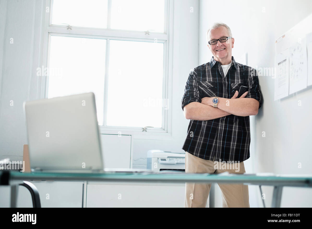 Portrait of smiling man in modern office Stock Photo - Alamy