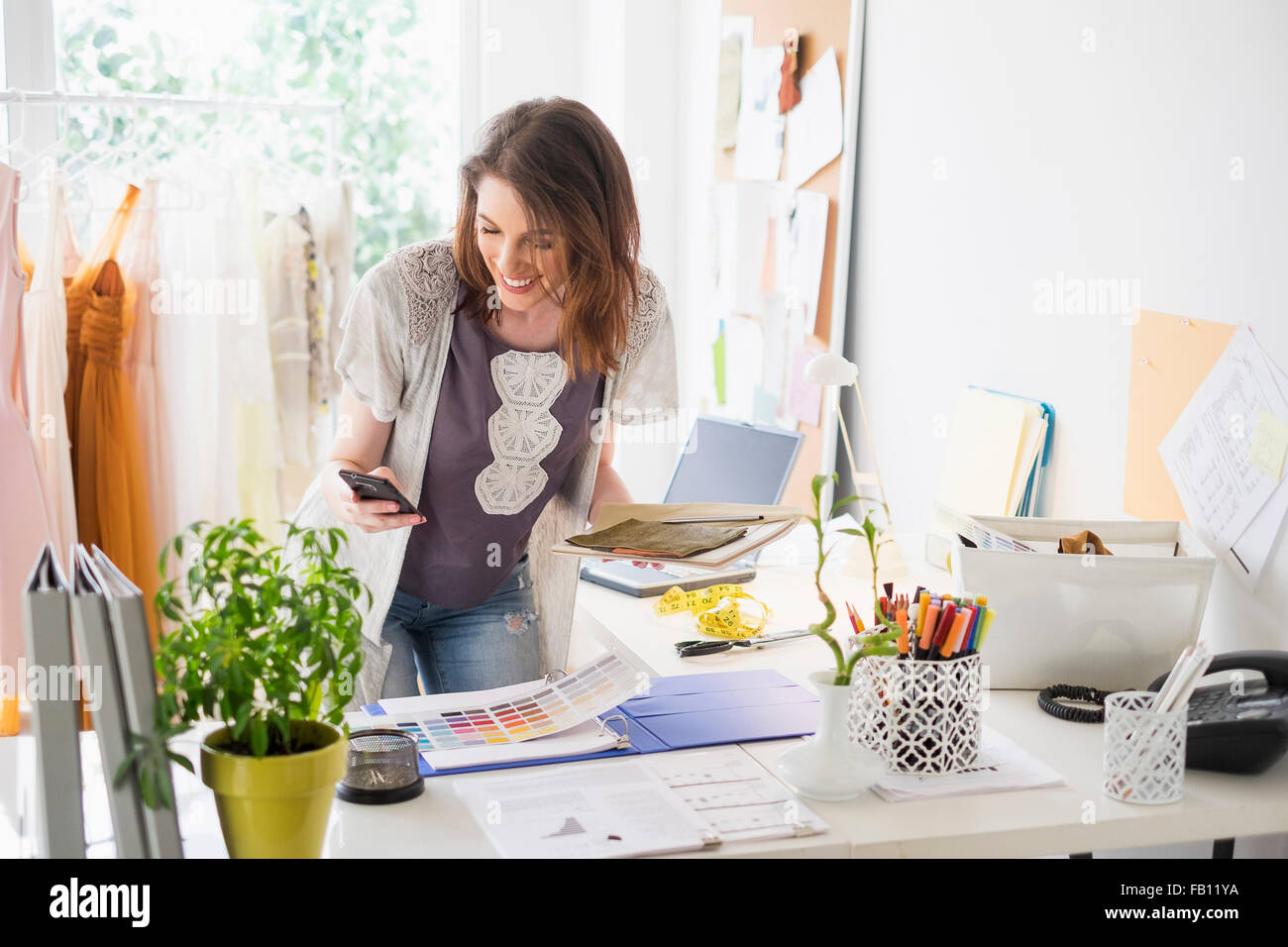 Female fashion designer in her office Stock Photo - Alamy