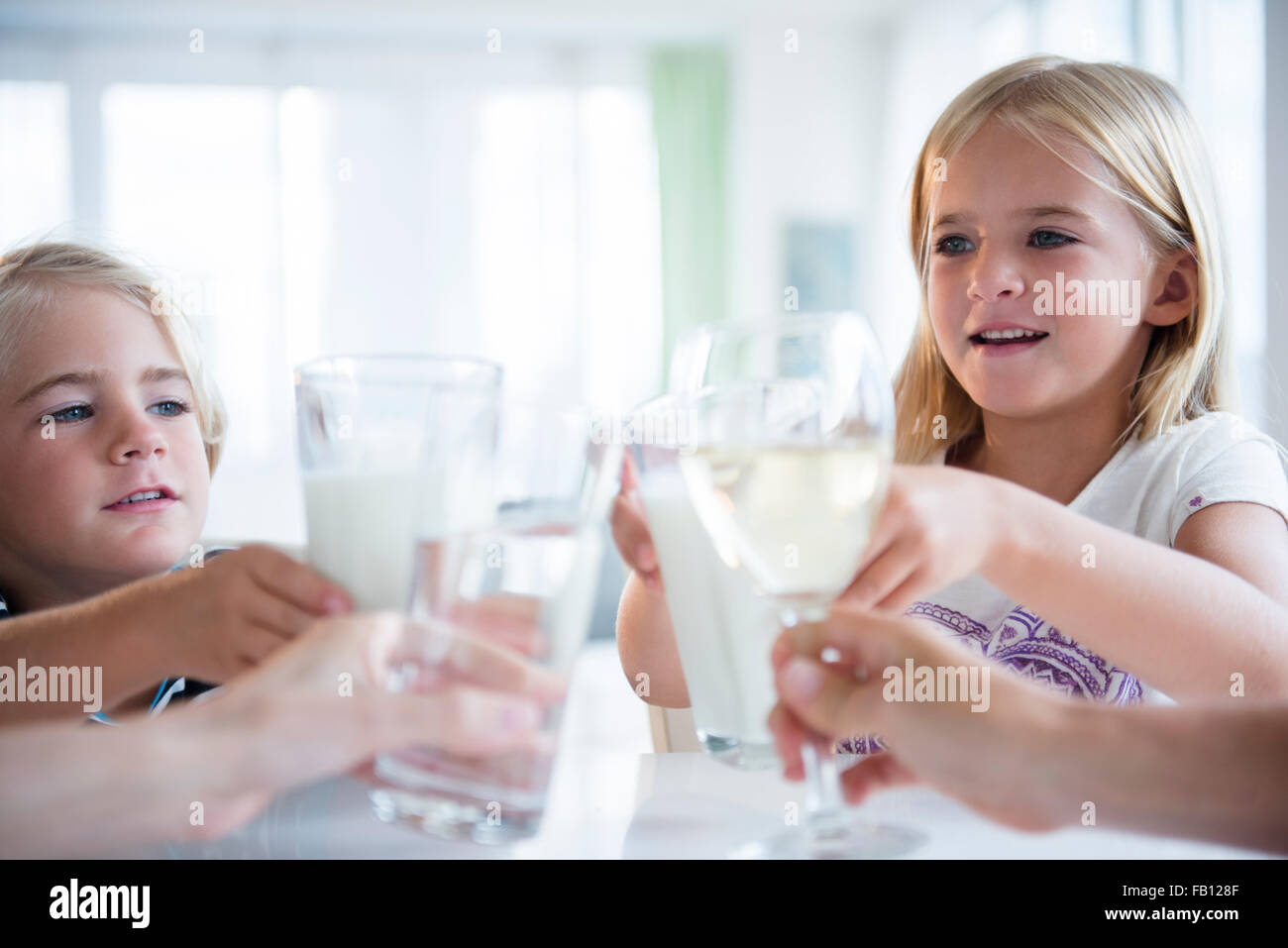 Family with son (4-5) and daughter (6-7) drinking refreshments Stock Photo