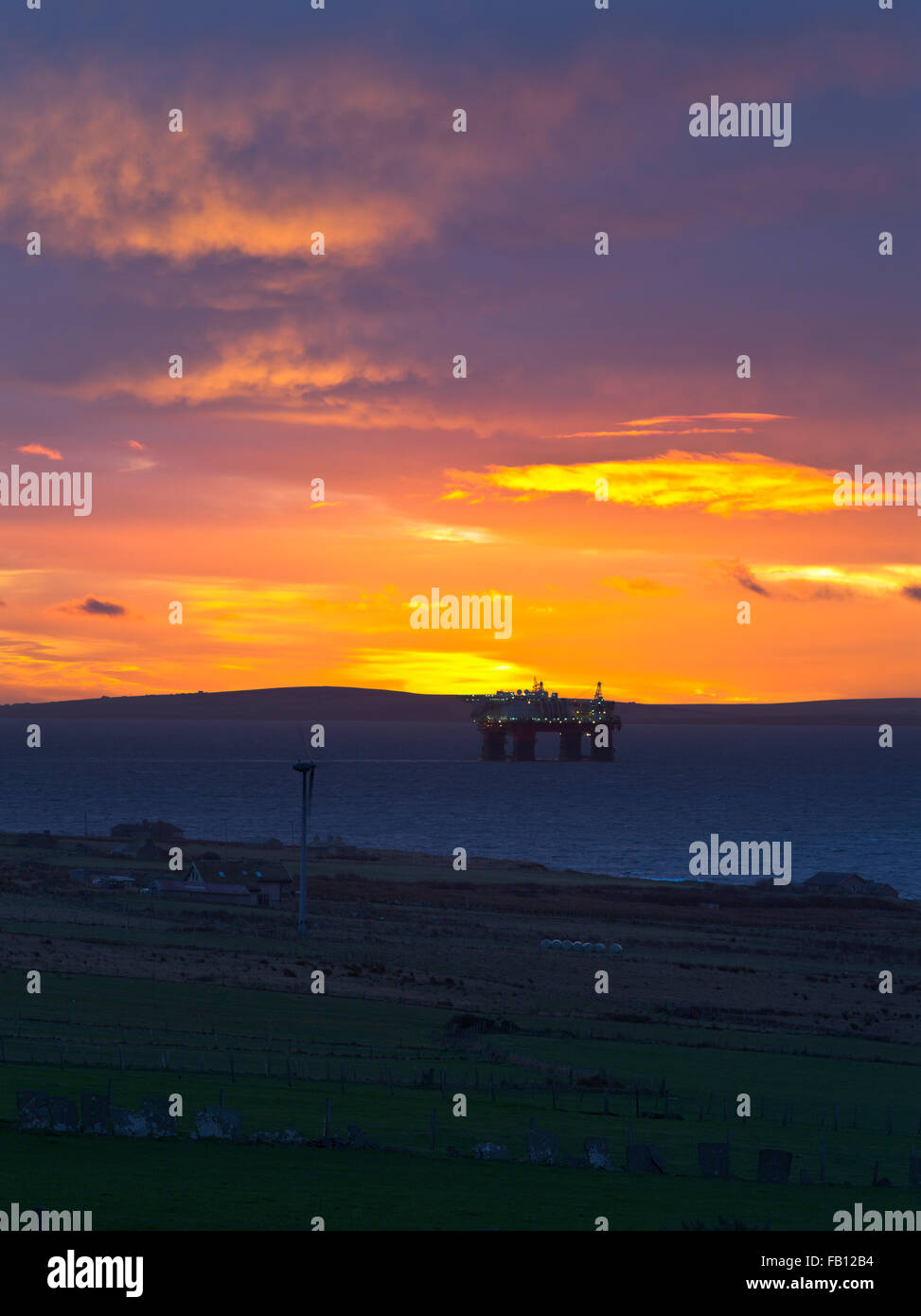 dh  SCAPA FLOW ORKNEY wind turbine sunrise sky oil rig platform anchored sea scotland uk sun rise Stock Photo