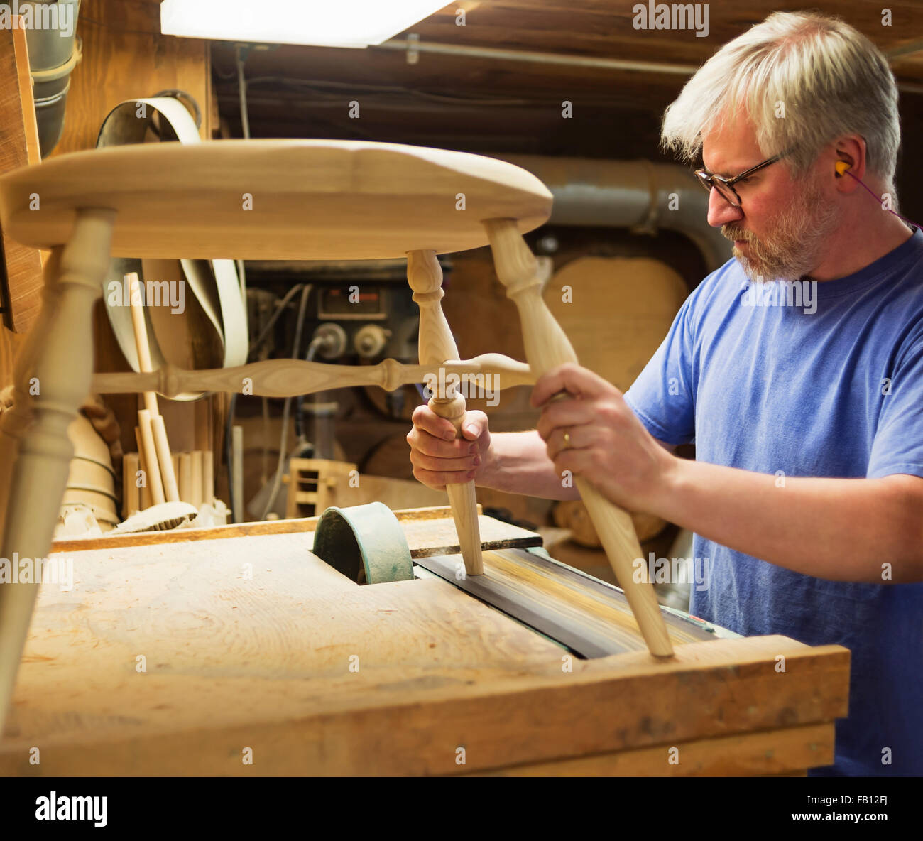 Carpenter polishing chair with sander Stock Photo Alamy