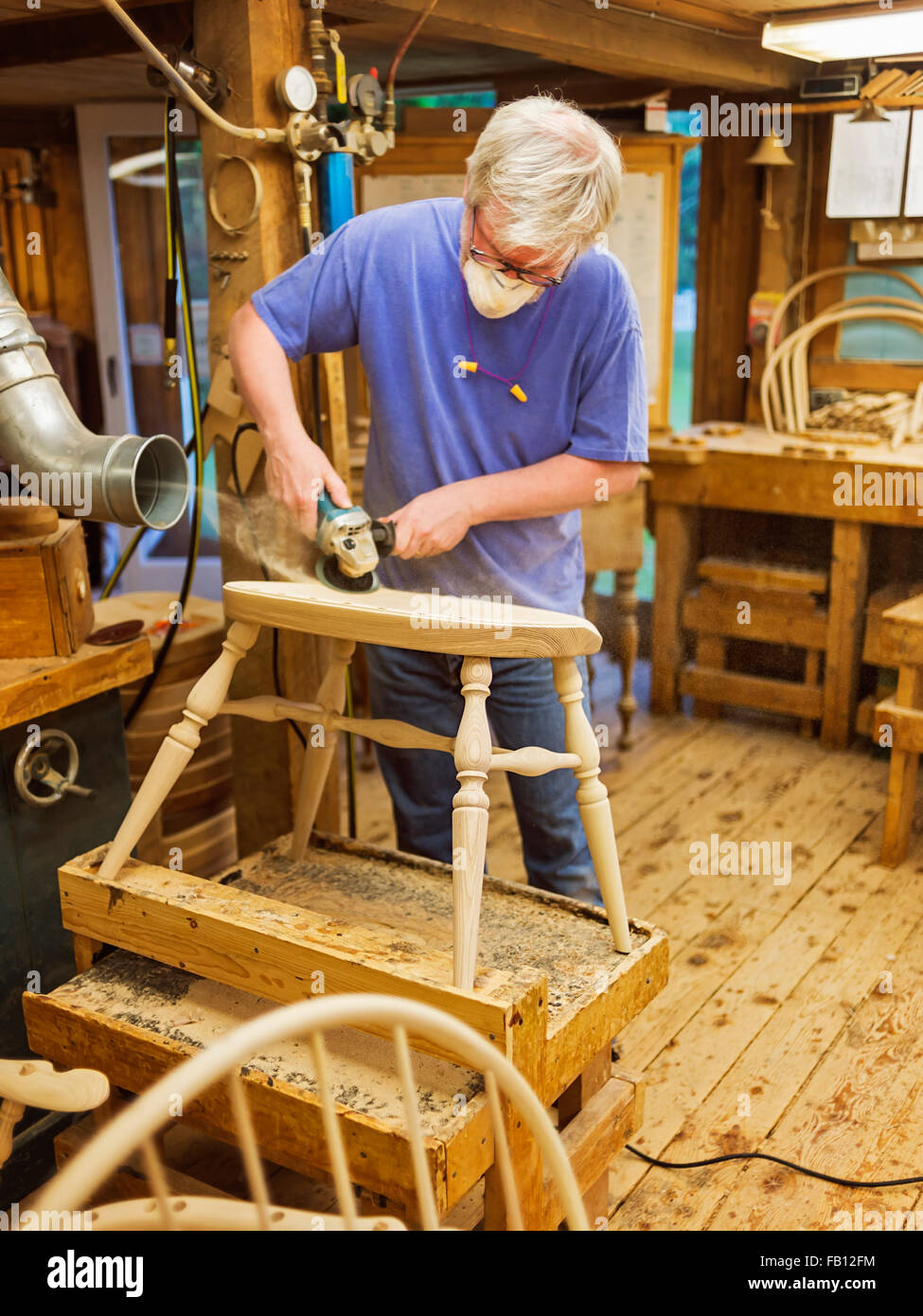 Carpenter polishing chair with sander Stock Photo Alamy