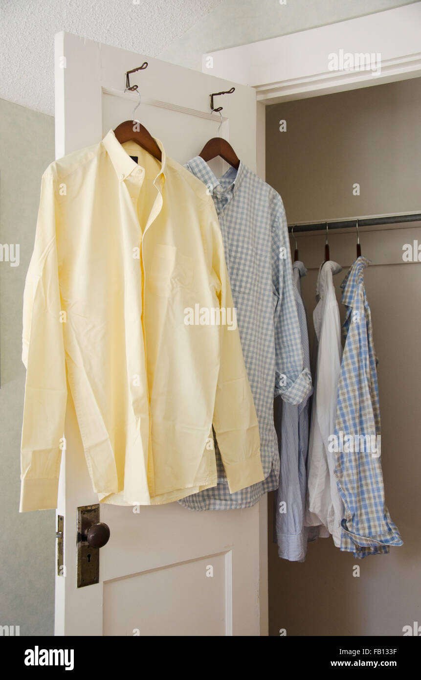 Button down shirts hanging on cloth hangers Stock Photo Alamy