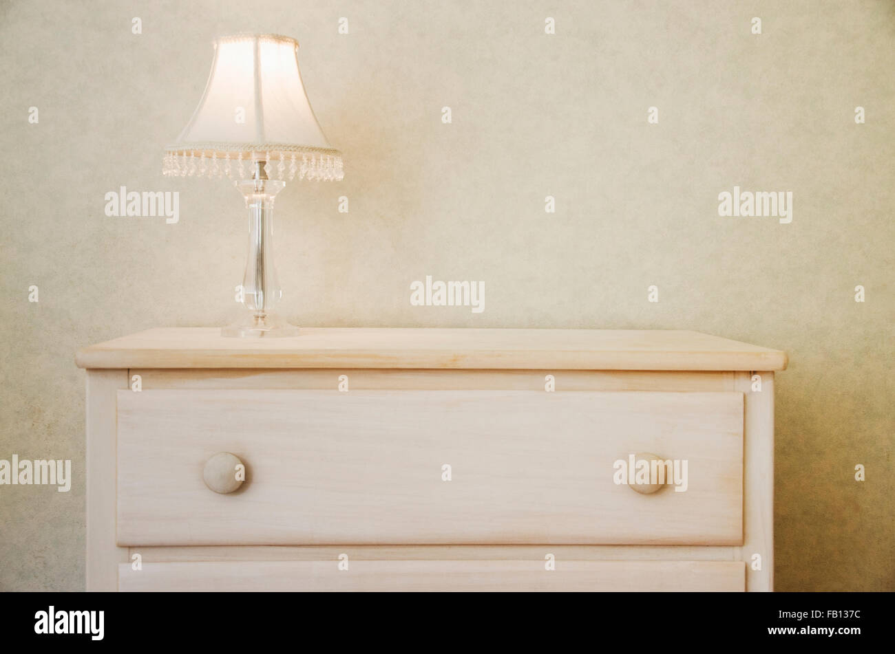 Electric lamp on wooden dresser Stock Photo