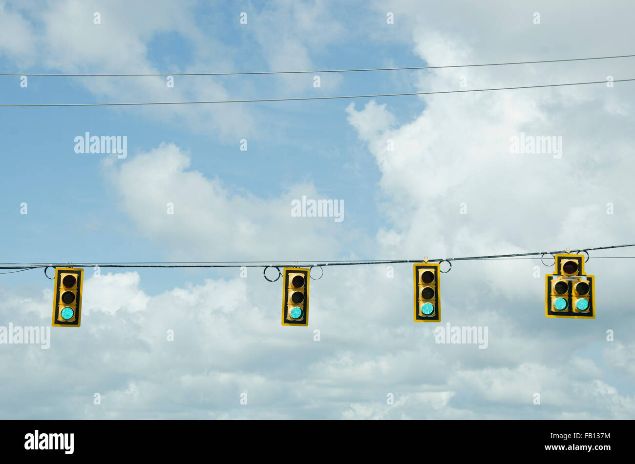 Road signals on cable against cloudy sky Stock Photo