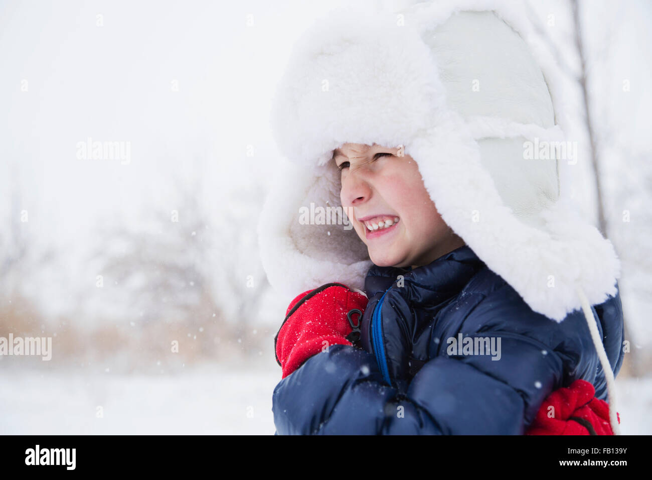 Portrait of boy (6-7) in fur hat and gloves Stock Photo