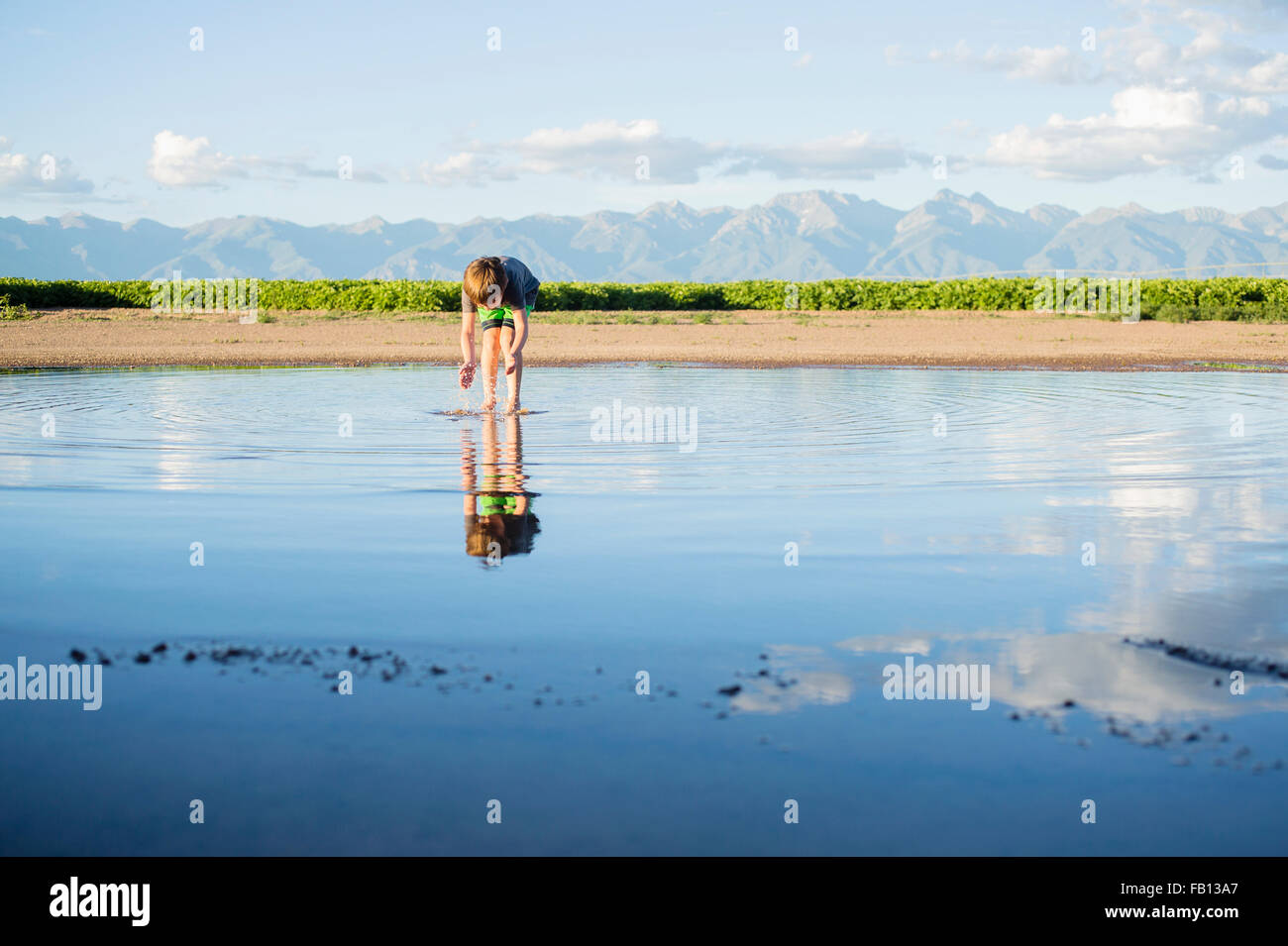 Boy (6-7) wading in water Stock Photo