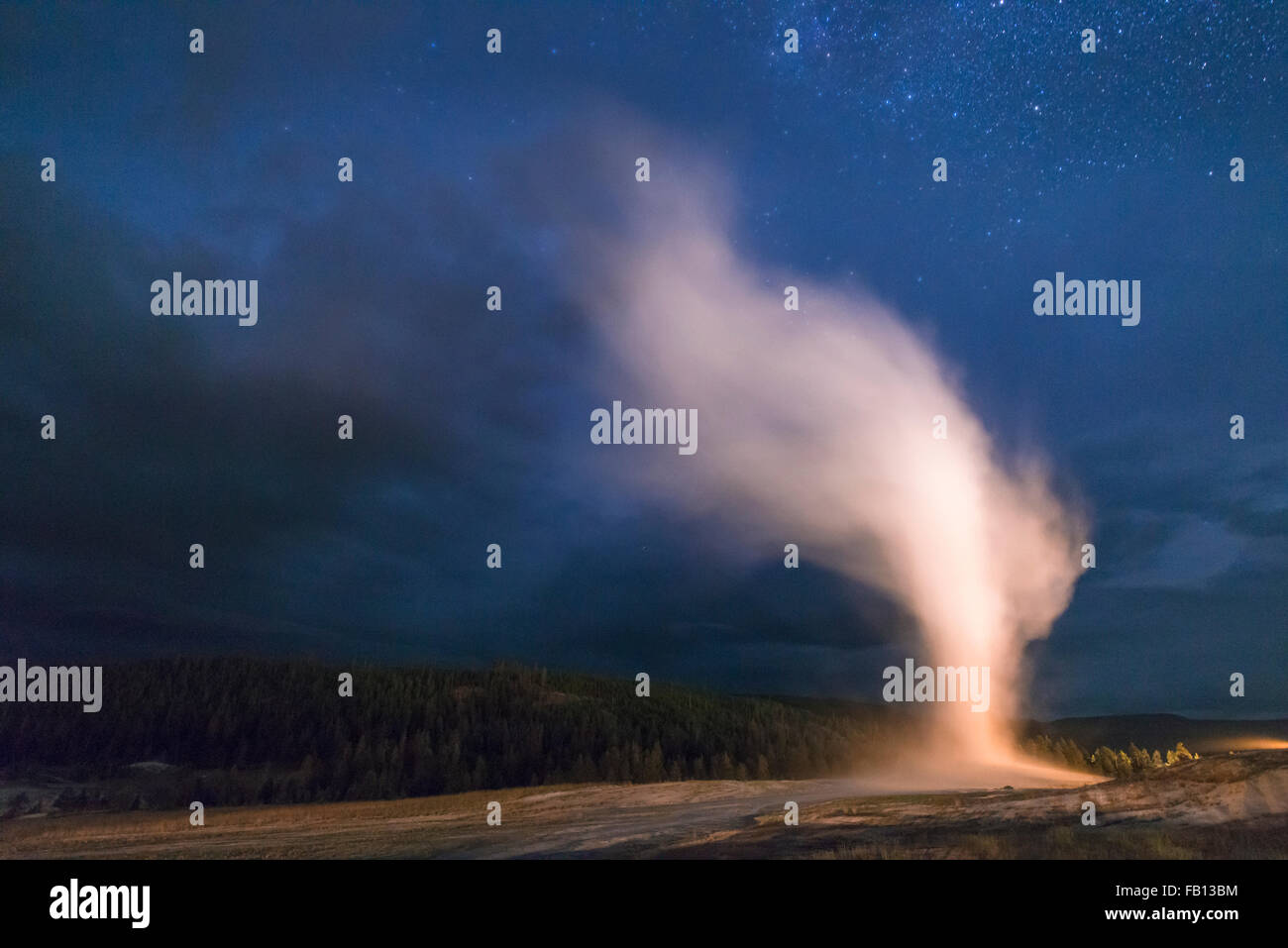 Geyser erupting at night Stock Photo