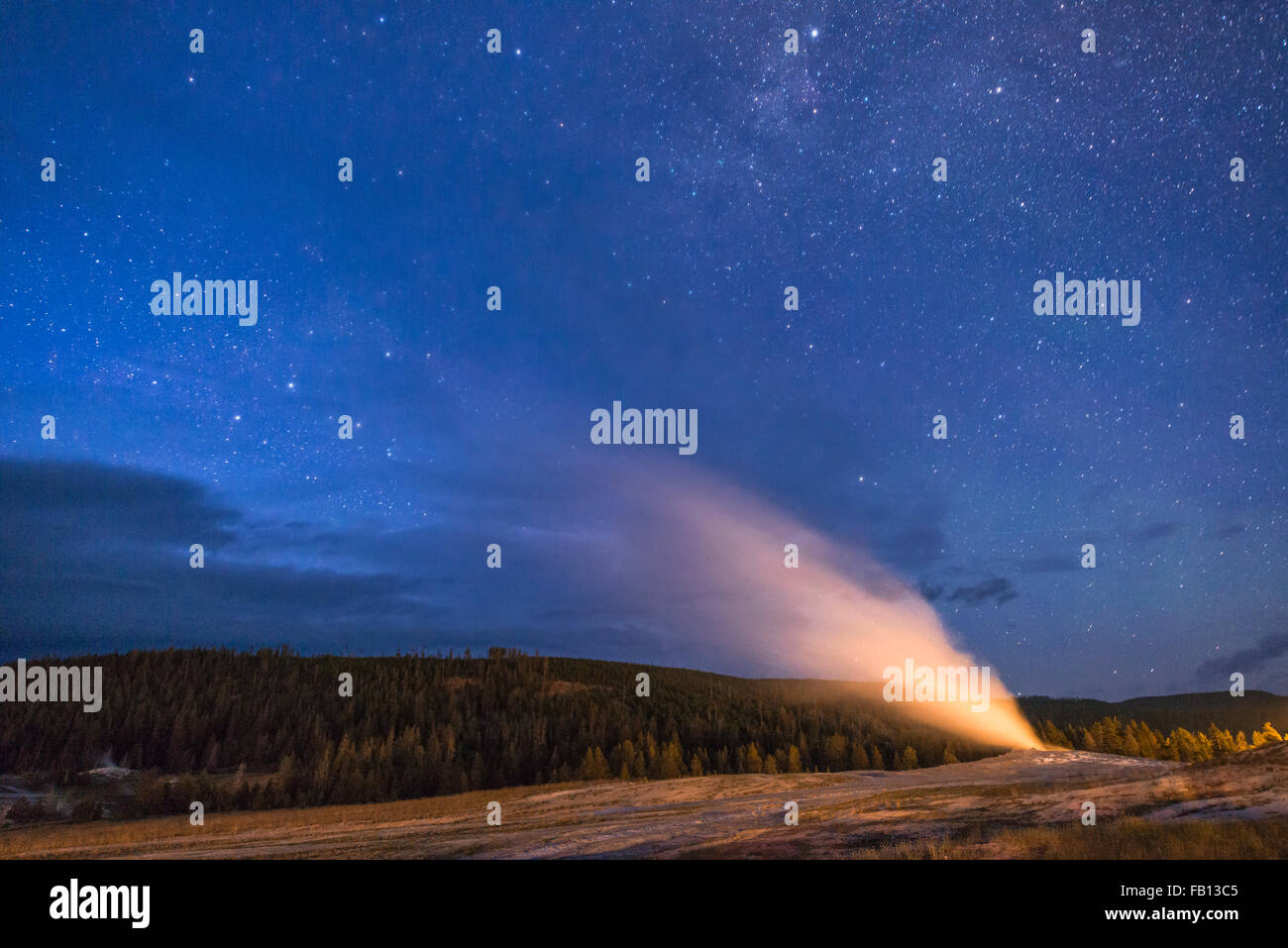 Geyser erupting at night Stock Photo
