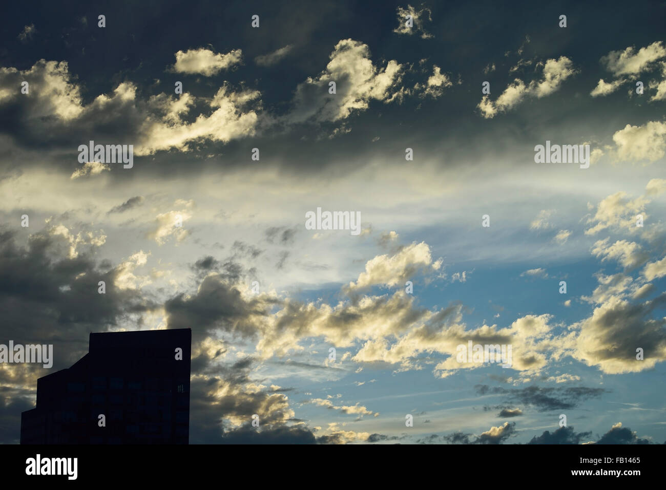 Office building against dramatic sky Stock Photo - Alamy