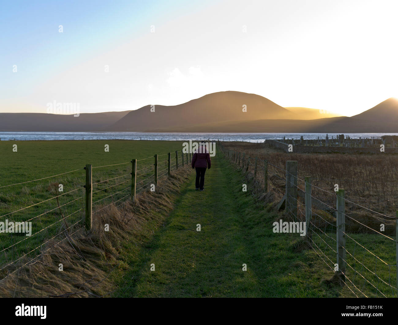 dh  HOY SOUND ORKNEY Woman walking footpath winter sunset Hoy Hills uk outdoors walk Stock Photo