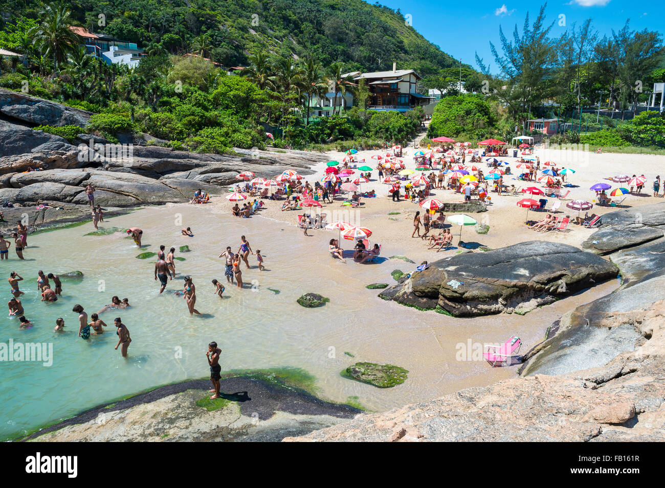 RIO DE JANEIRO, BRAZIL - OCTOBER 31, 2015: Beachgoers take advantage of a sunny weekend at Itacoatiara Beach, in Niteroi. Stock Photo