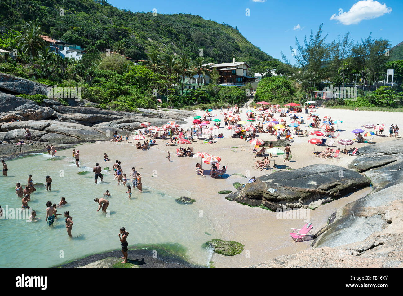 RIO DE JANEIRO, BRAZIL - OCTOBER 31, 2015: Beachgoers take advantage of a sunny weekend at Itacoatiara Beach, in Niteroi. Stock Photo