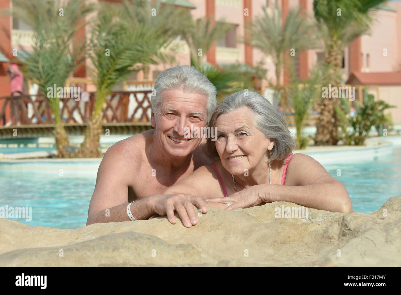 Senior couple relaxing at pool Stock Photo - Alamy