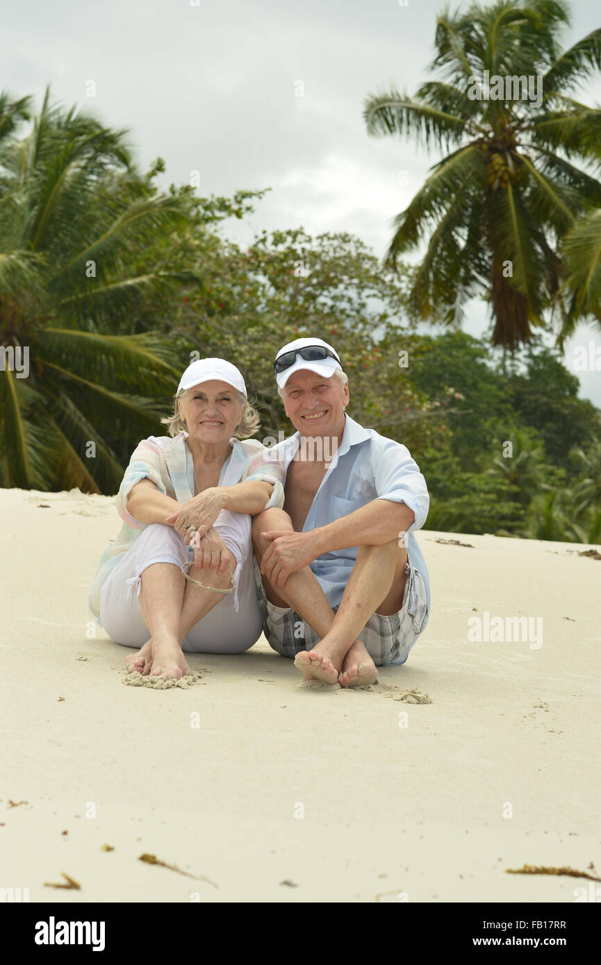 Elderly couple sitting on a bench outdoors Stock Photo - Alamy