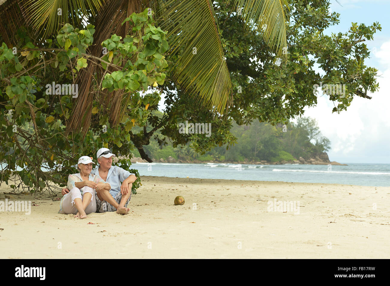 Elderly couple sitting on a bench outdoors Stock Photo - Alamy