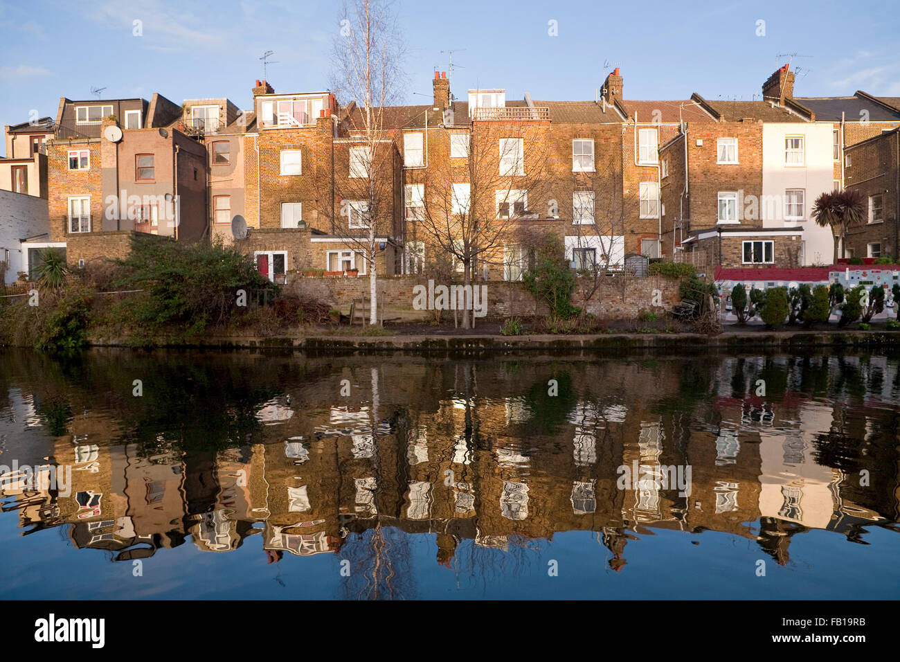 Reflections in the Grand Union Canal. Row houses sitting in the winter