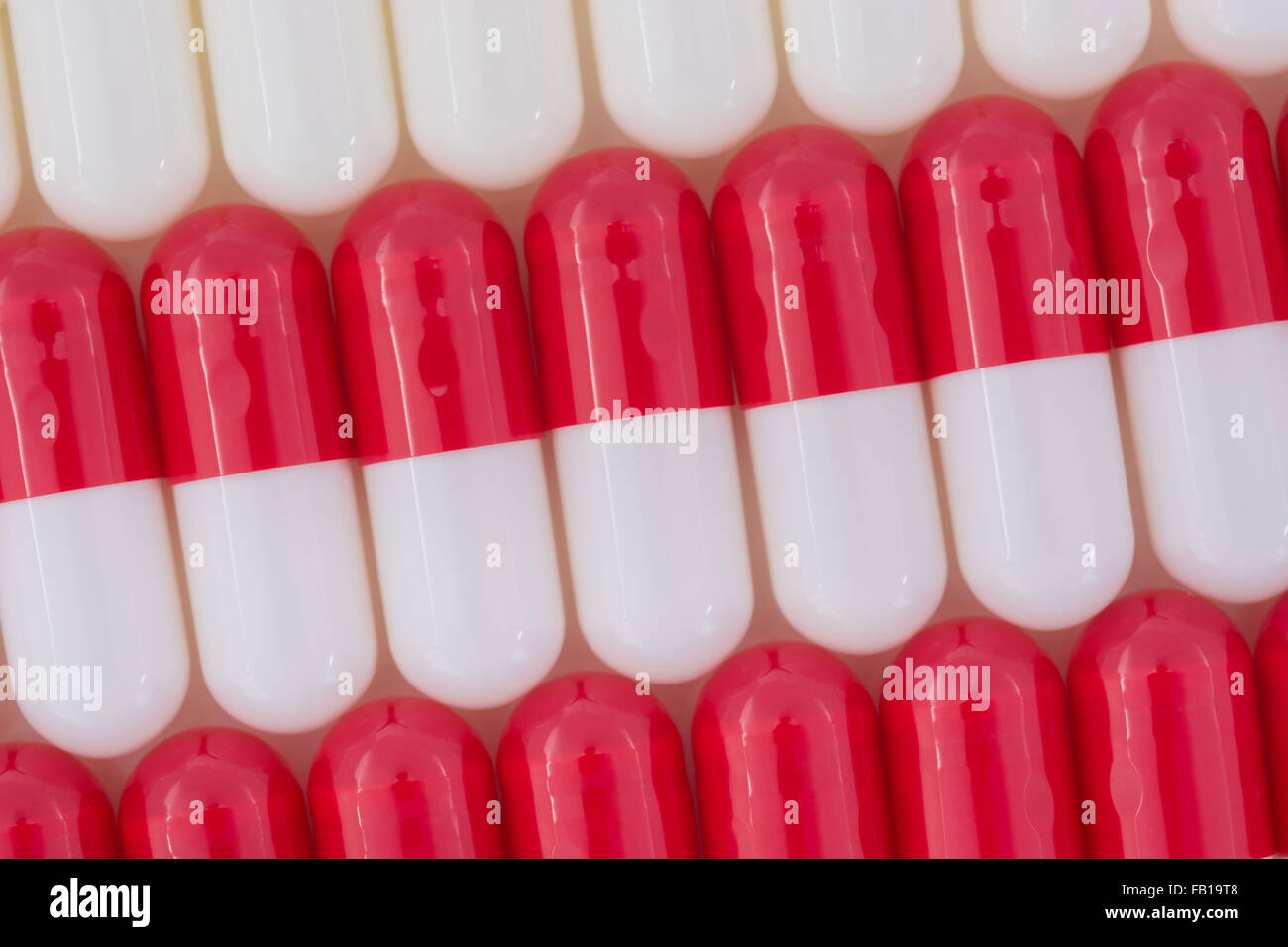 Closeup of pills capsule form made of gelatin. Red / White pills. Metaphor taking on American
