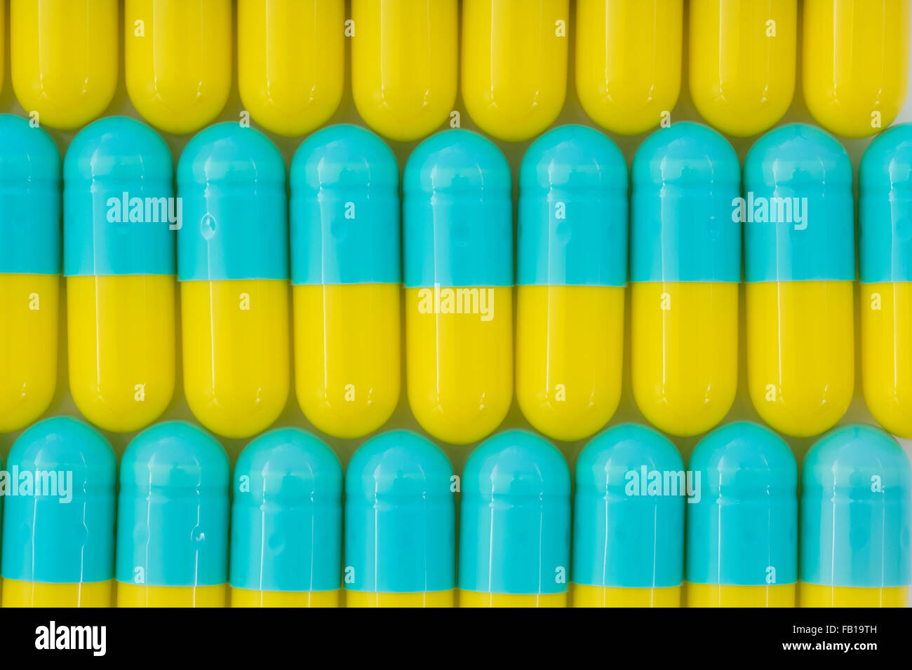 Closeup of pills capsule form made of gelatin.Yellow / Blue pills