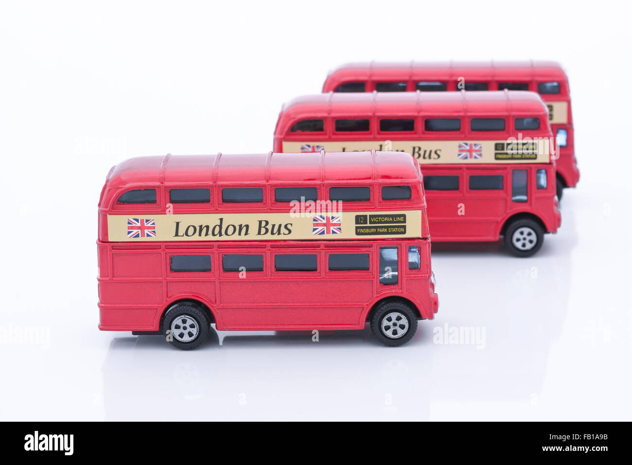 Three toy (die cast) London buses lined up. Metaphor for getting around ...