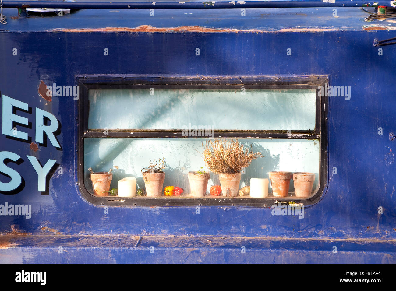 Narrow Boat Window. The narrow boats on the canals of England provide an alternative to caravans. The floating homes can be owne Stock Photo