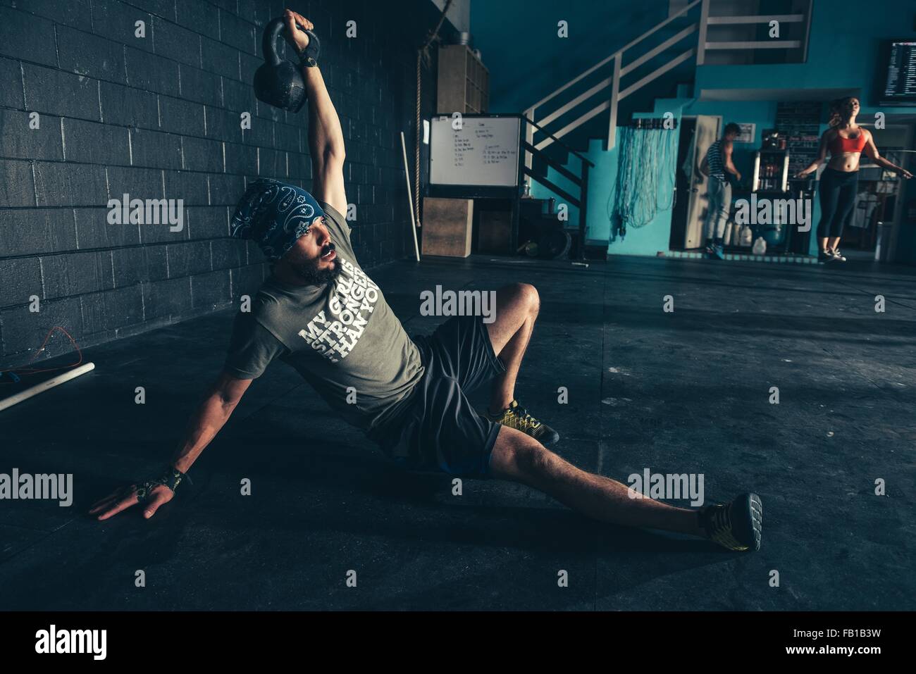 Man lifting kettlebell in  gym Stock Photo