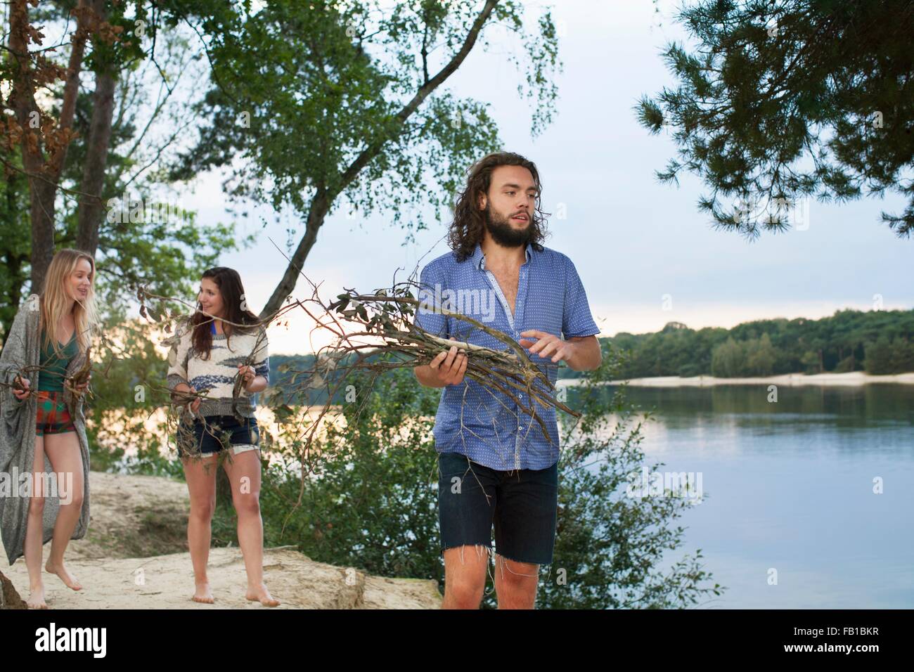 Friends camping by lake Stock Photo