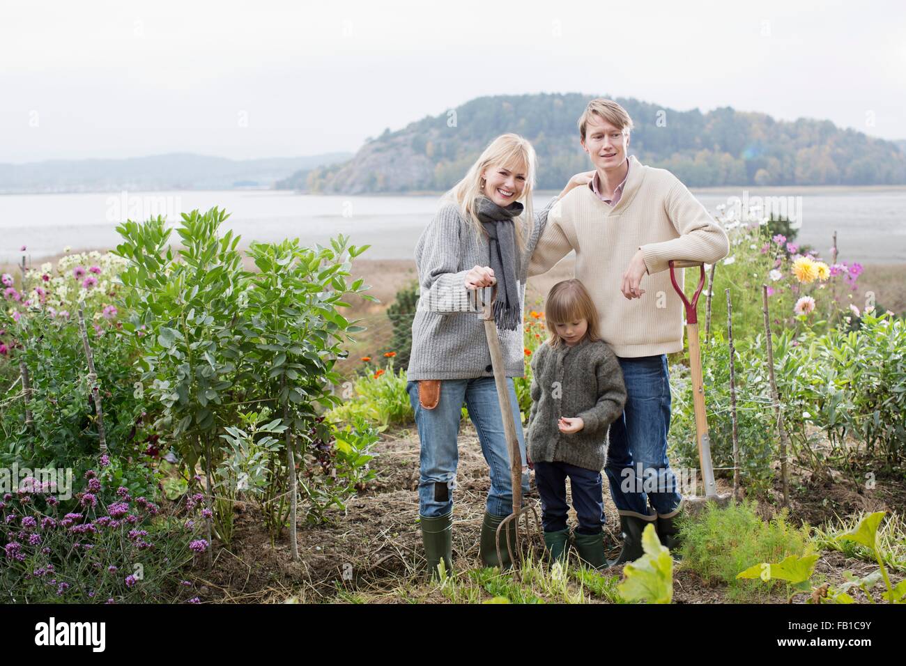 Portrait of couple and son digging organic garden, Orust, Sweden Stock Photo