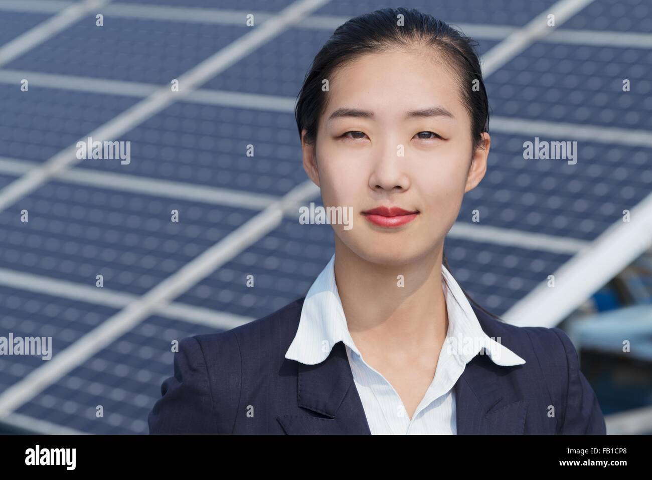 Businesswoman on roof of solar panel assembly factory, Solar Valley, Dezhou, China Stock Photo