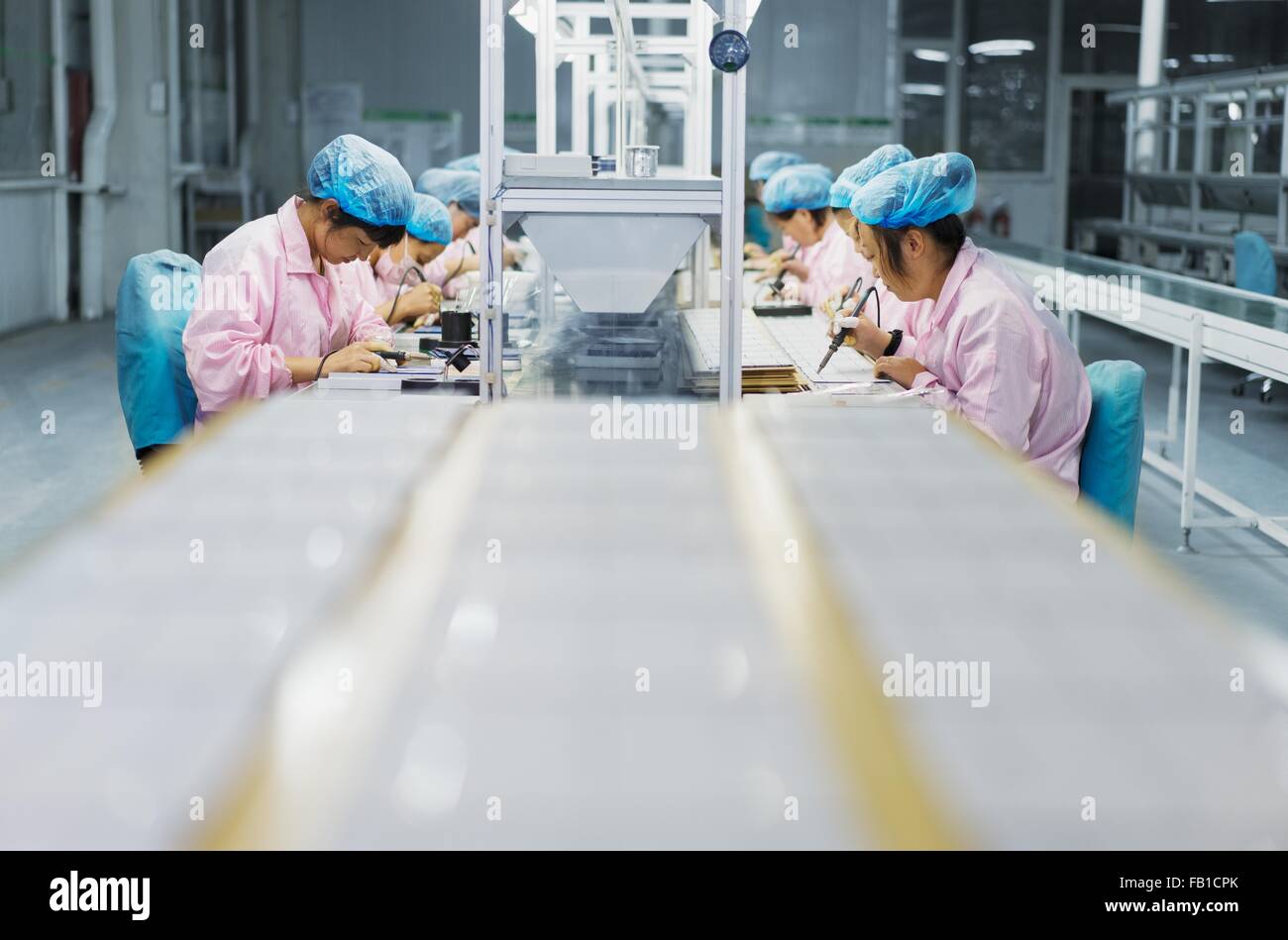 Female workers in solar panel assembly factory, Solar Valley, Dezhou, China Stock Photo