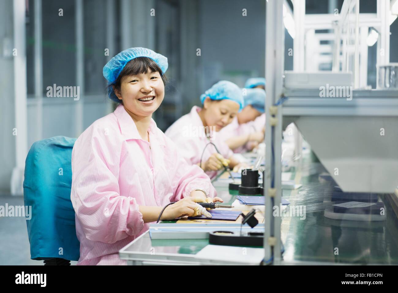 Female workers in solar panel assembly factory, Solar Valley, Dezhou, China Stock Photo