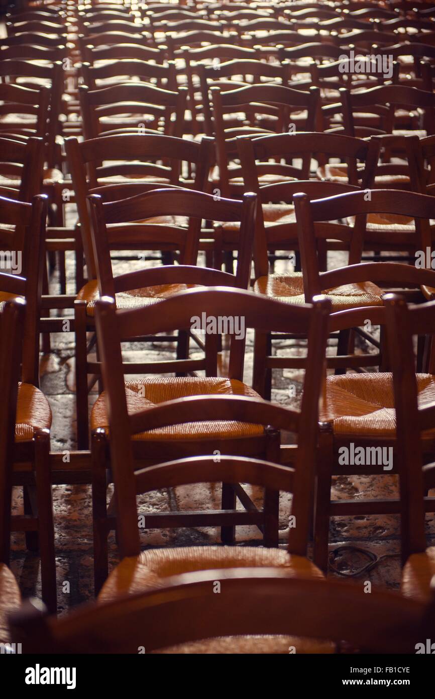 Rows of traditional wooden chairs Stock Photo