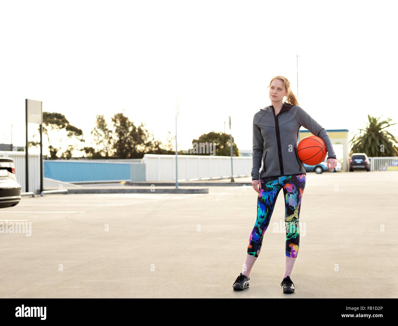 Young woman holding basketball in hi-res stock photography and images ...