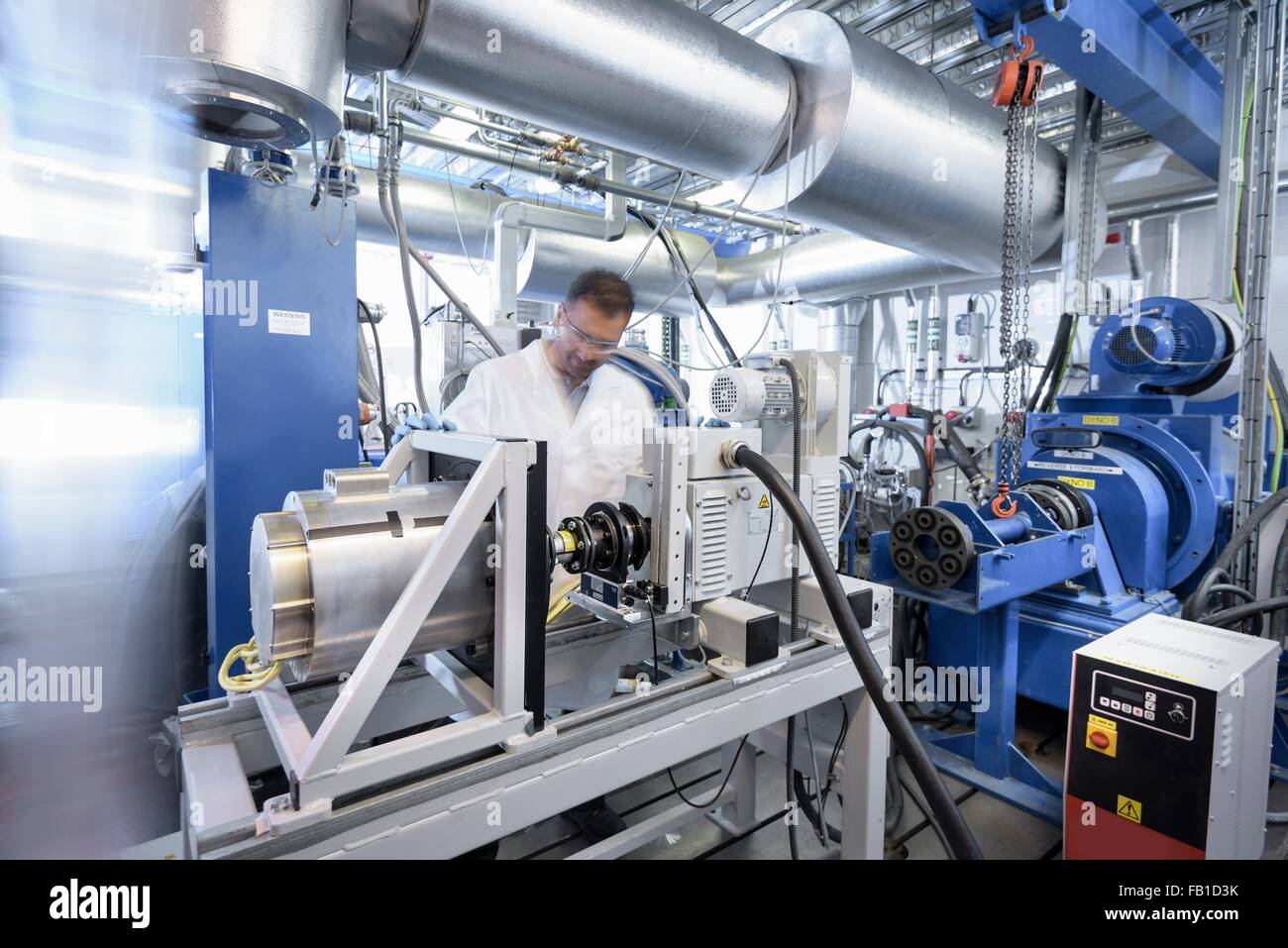 Scientists testing lithium car battery with electric motor car in