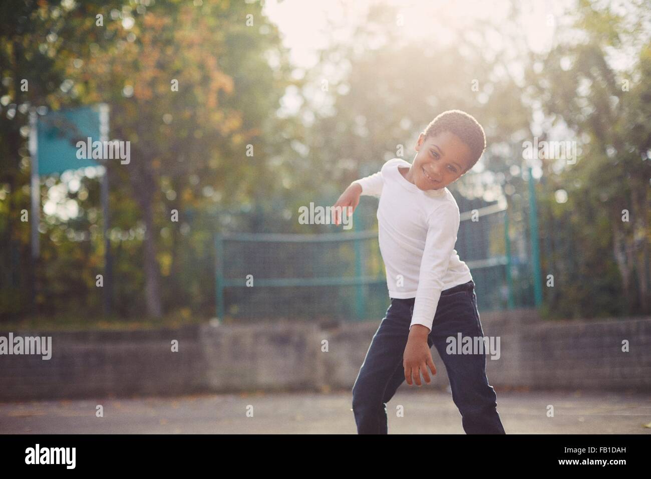 Elementary schoolboy dancing in playground Stock Photo