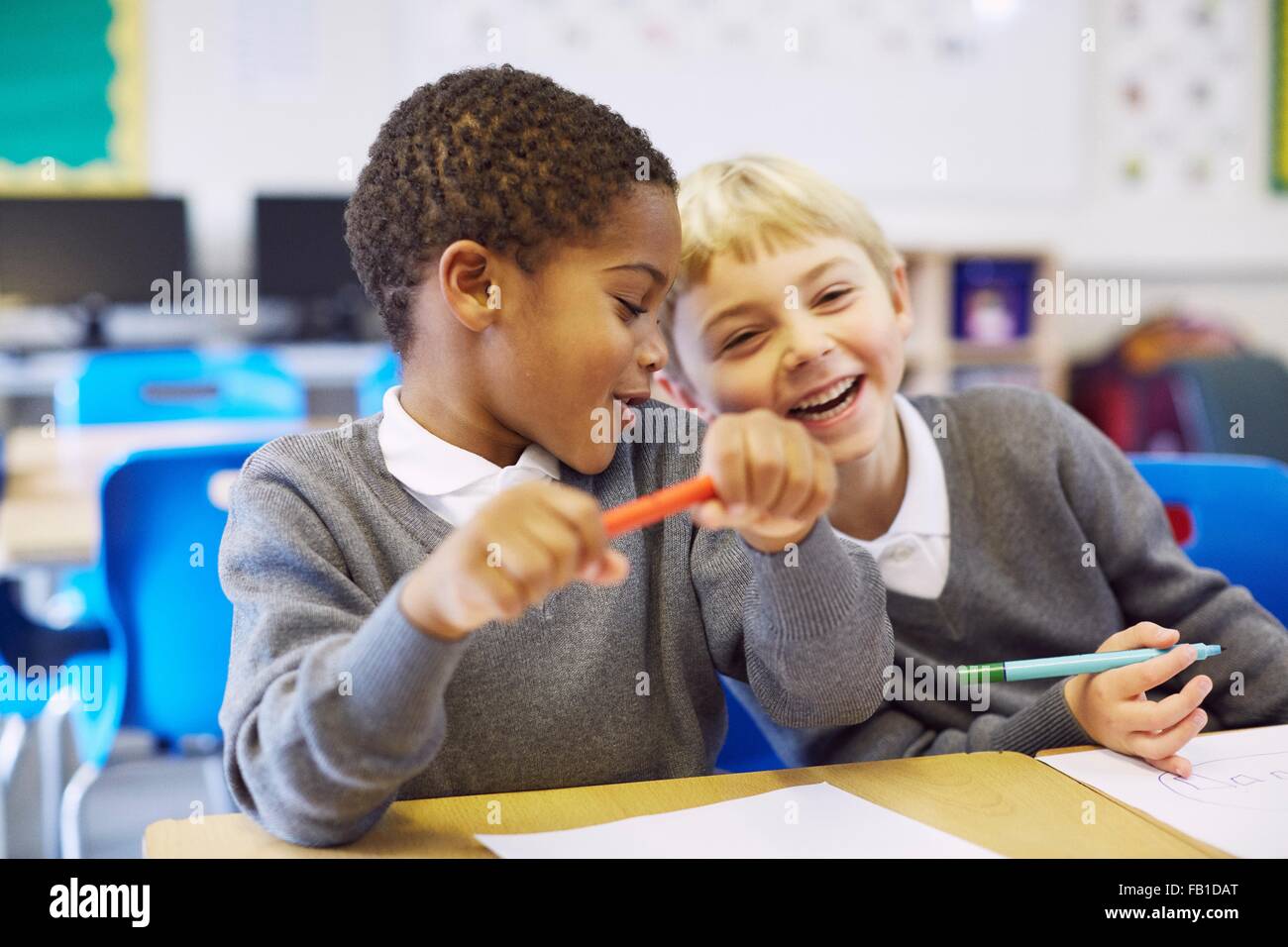 Mischievous boys in elementary school classroom Stock Photo