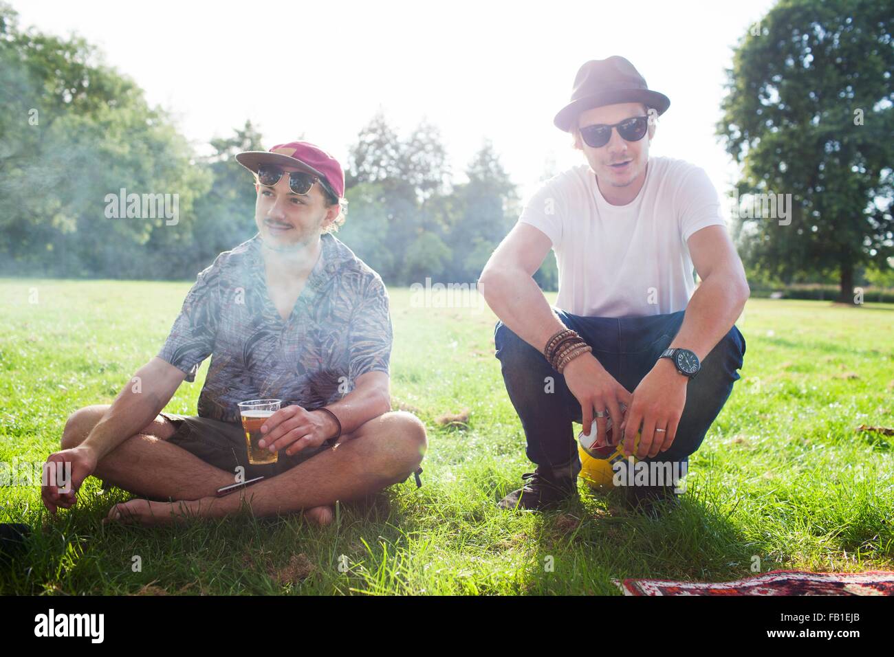 Portrait of two cool male friends at park party Stock Photo