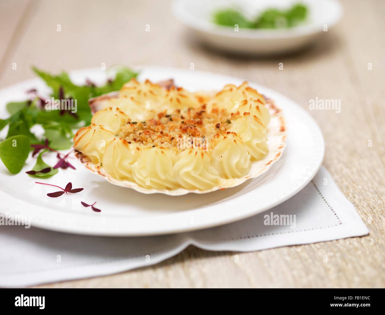 Coquille st jacques, scallops, potatoes and green salad leaves Stock Photo