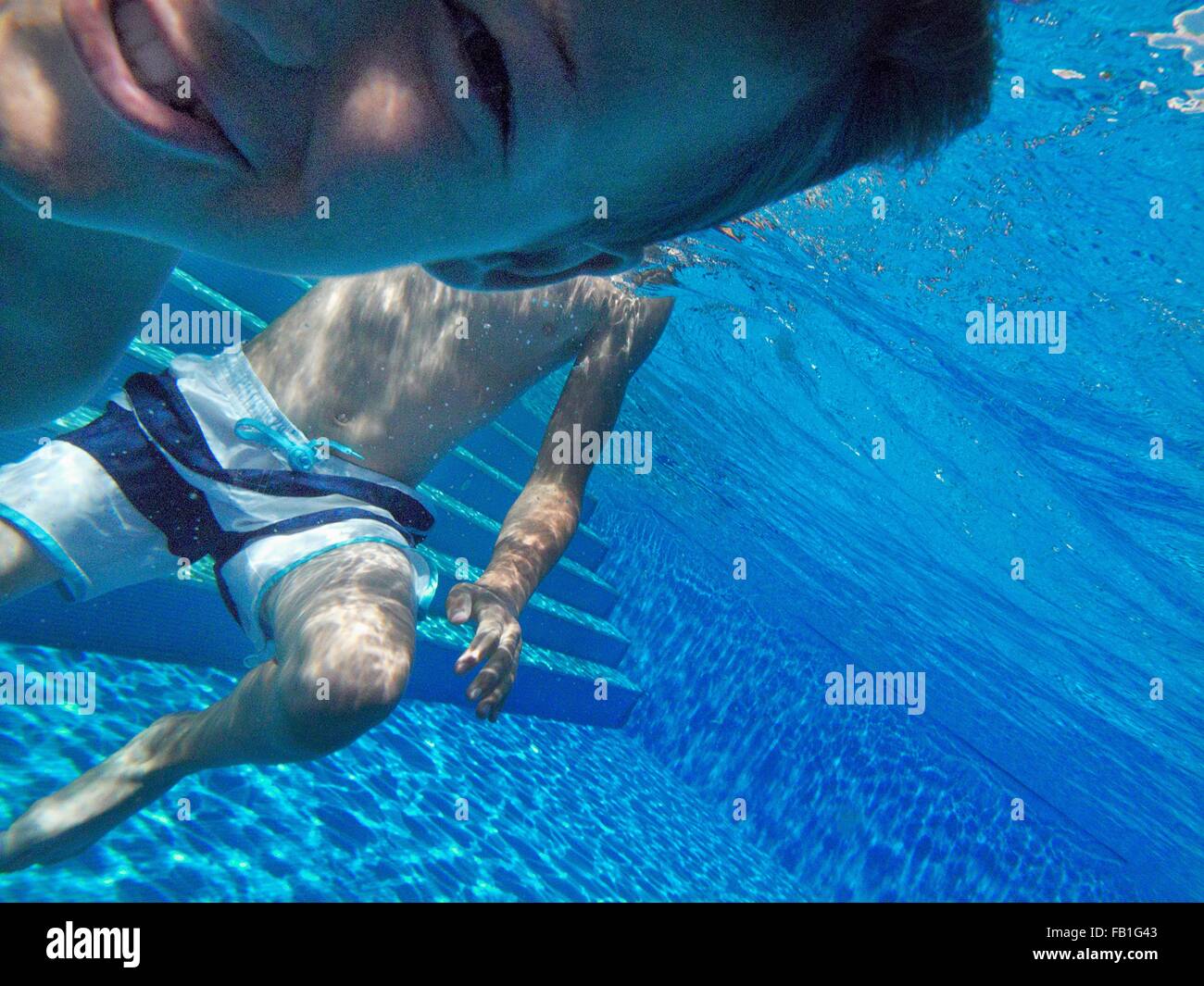 Boy swimming underwater in pool hi-res stock photography and images - Alamy