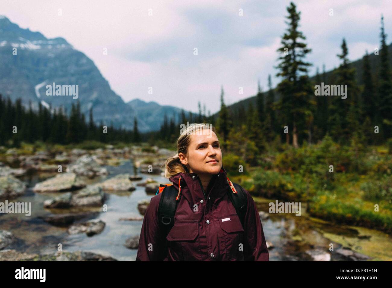 Mid adult woman hiking on Moraine Lake, looking away, Banff National Park, Alberta Canada Stock Photo