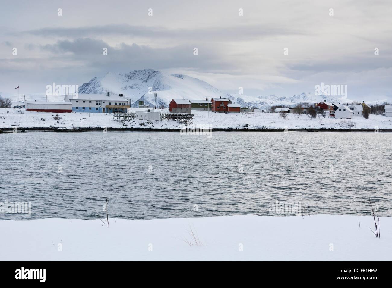 Snow covered landscape and distant houses, Andenes, Lofoten Islands, Norway Stock Photo