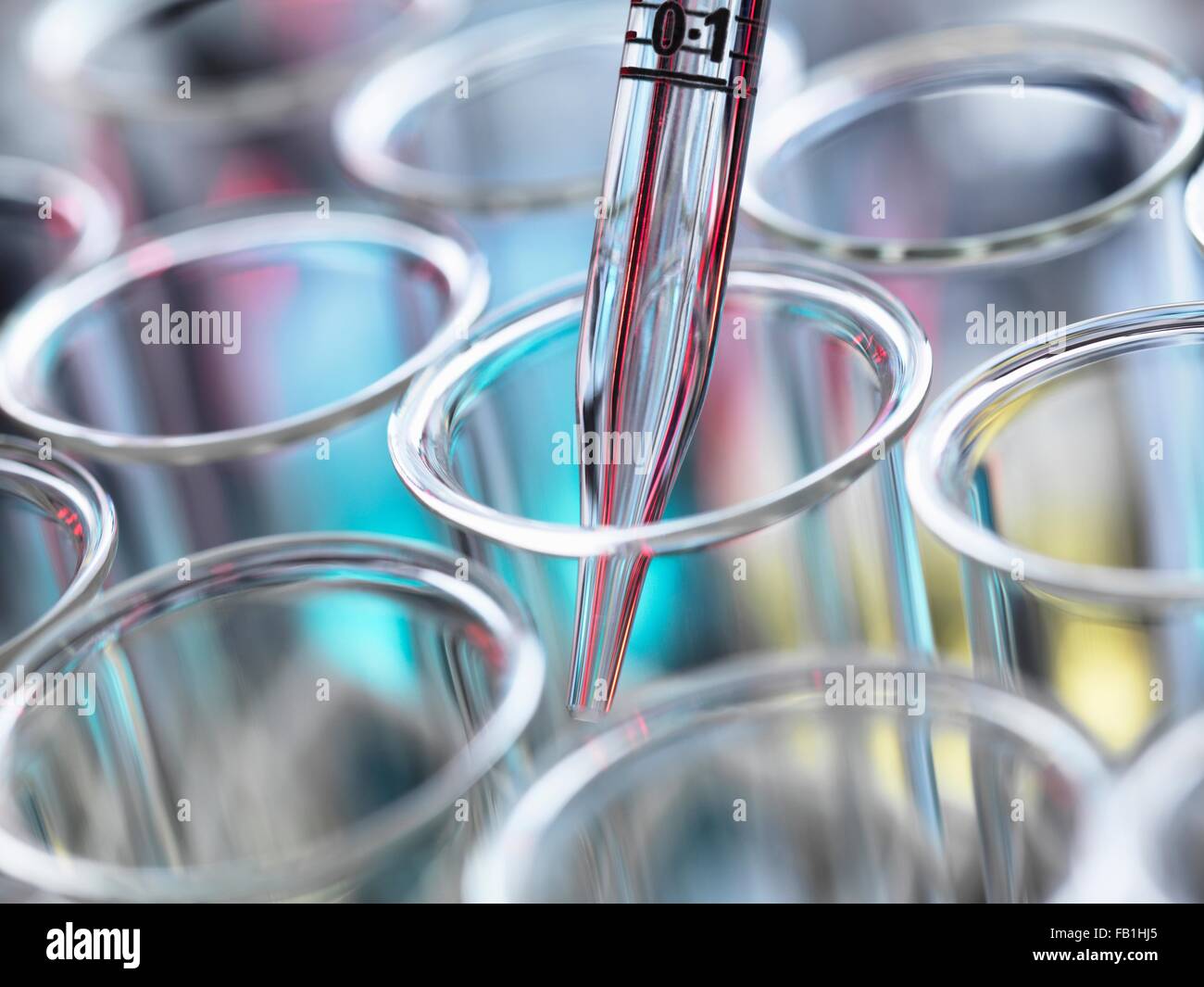 High angle cropped view of graduated pipette pipetting liquid into test