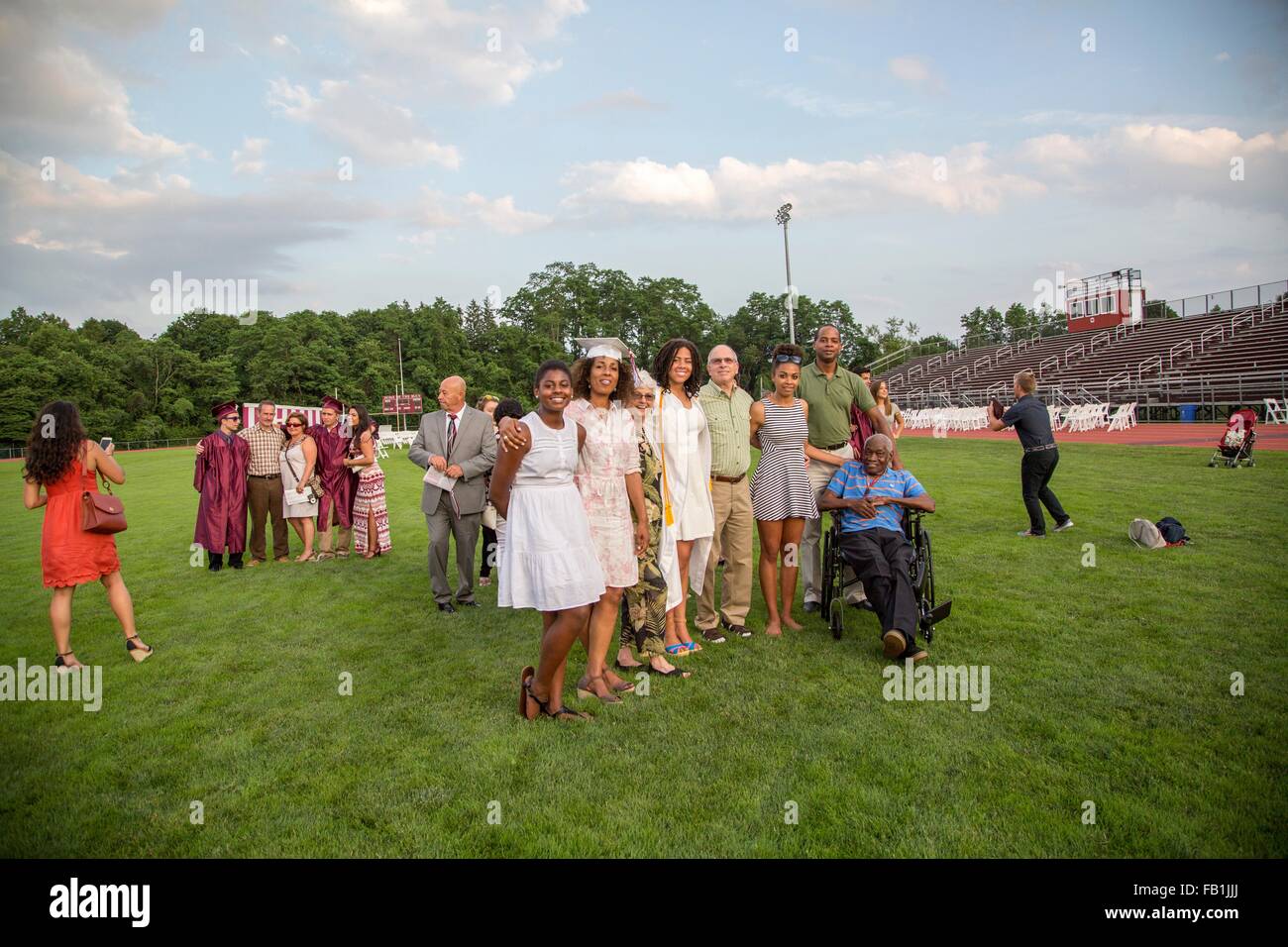 Teenage girl with three generation family at graduation ceremony Stock Photo