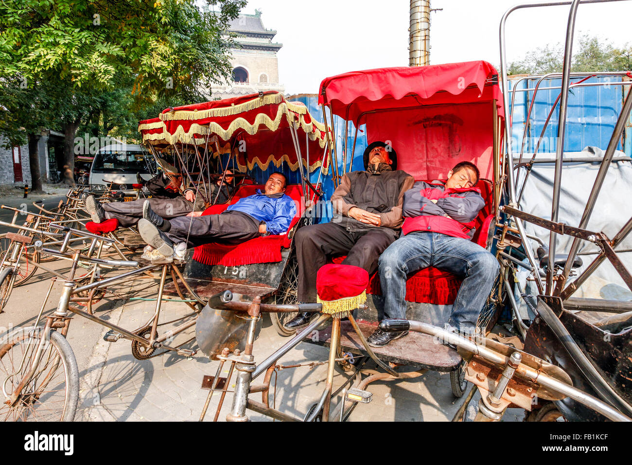 Rickshaw drivers on a break after taking tourist on a tour in the Houhai lakes area Beijing China Stock Photo